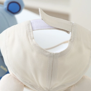 Detail of adjustable velcro strap on cream cotton twill baseball cap for kids