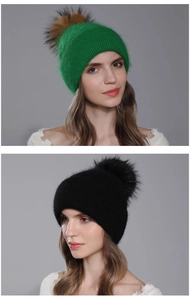 Detailed view of women's soft angora knit beanie with a large fluffy fur pom-pom