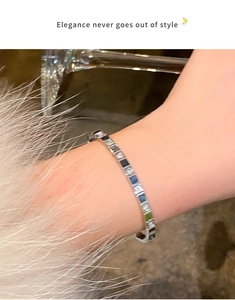 Detail of tennis bracelet featuring alternating blue and clear square-cut zircon stones