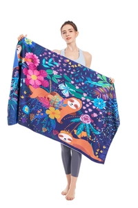 Detail of microfiber beach towel featuring blue sloth print and tropical floral pattern