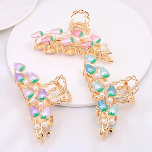 Detailed view of floral tulip alloy hair claws in pink, purple and blue with pearls