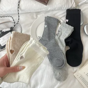 Detail of embroidered heart socks and She is King text on premium cotton knit crew socks