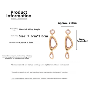 Detail view of large geometric acrylic triangle earrings with gold frame and silver needle