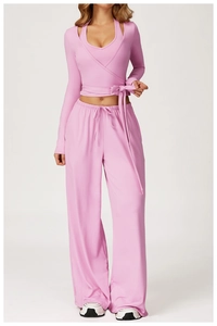 Pink two-piece yoga set featuring cross-wrap crop top and drawstring wide-leg pants
