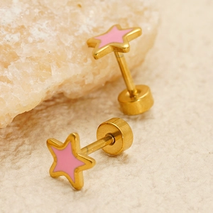 Minimalist pink enamel star stud earrings with gold plating and textured stone background