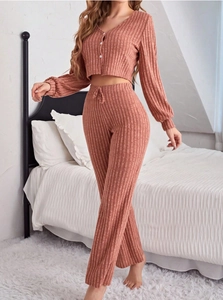 Close-up of ribbed knit pajamas featuring button-down top and drawstring high-waist pants