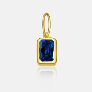 Detail of s925 silver rectangle pendant with blue zircon and golden frame reflection