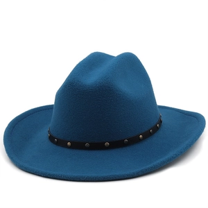 Detailed close-up of blue felt cowboy hat with black leather belt and metal studs