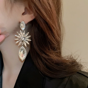Sparkling crystal flower and teardrop dangle earrings on model for a luxury look