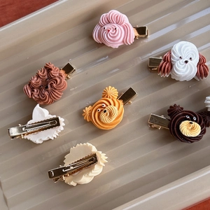 Set of 7 cartoon dog cookie hair clips with colorful cream textures and gold metal grips