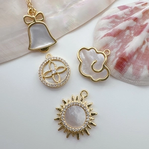 Macro view of 18K gold plated charms with white shell and zircon for DIY jewelry making