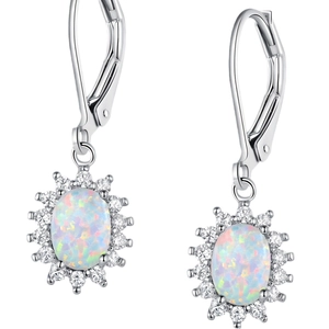 Macro shot of silver drop earrings featuring white oval opal and cubic zirconia halo