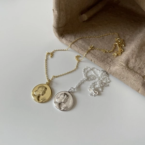 Minimalist 925 sterling silver coin necklace with vintage embossed portrait in gold and silver