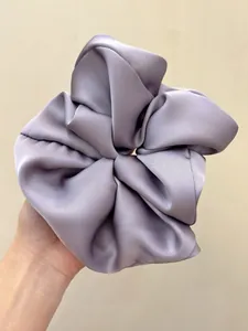 Detail shot of large oversized lavender satin hair scrunchie with smooth silk texture