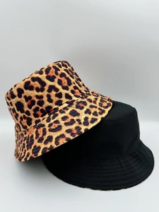 Detail shot of leopard print and solid black bucket hats with reinforced brim stitching