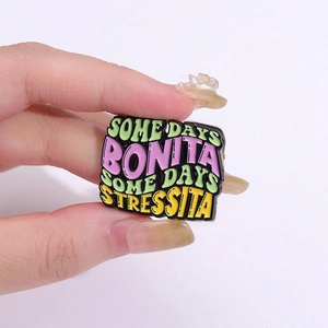 Colorful enamel brooch with Some Days Bonita Some Days Stressita text on hand
