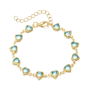 Detail of gold chain bracelet with eleven light blue heart gems and lobster clasp closure