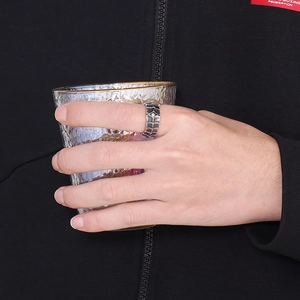 Close-up of vintage dragon scale stainless steel ring with intricate textured carving