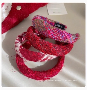 Detail of tweed knitted headbands in red and plaid patterns with premium texture