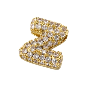 Macro view of gold letter Z pendant encrusted with sparkling white cubic zirconia stones