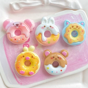 Colorful resin cartoon animal donuts including pink rabbit and blue cat on a white tray