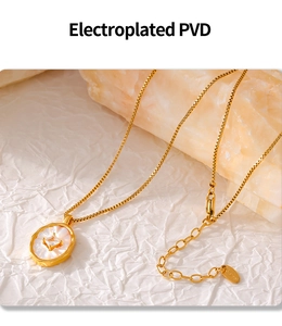 Macro detail of PVD plated gold necklace featuring oval mother of pearl and zircon stone