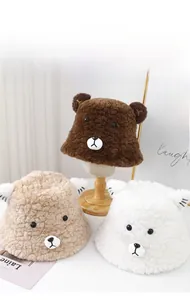 Close-up of fluffy bear ears bucket hats in coffee, beige, and white fleece textures