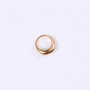 Detailed macro shot of a gold drop-shaped ring with a high-polished mirror finish