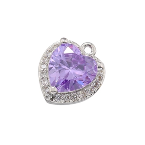 Detail of 18K gold heart pendant with purple gemstone and small clear cubic zirconia