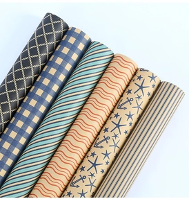 Macro view of six craft paper rolls featuring nautical motifs and geometric patterns