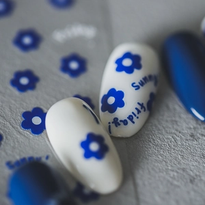 5D nail art stickers featuring blue flowers and Sunny Friday text on cement background