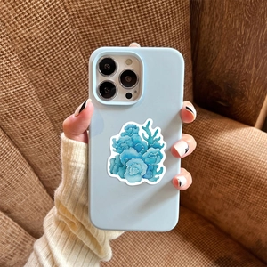 Close-up of light blue matte phone case featuring artistic blue coral watercolor patterns