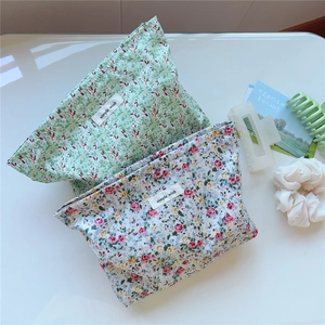 Detailed view of floral canvas makeup bags with zippers and simple wish logo tags