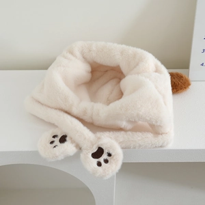 Detail of plush earflap hat with brown round ears and cat paw embroidery ties