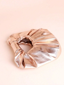 Detail shot of rose gold metallic pleated leather bag with a luxurious textured finish