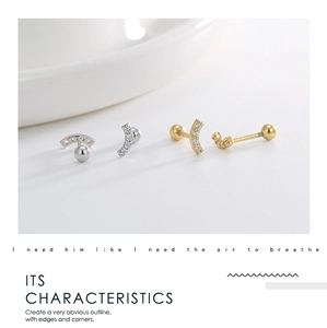 Detailed macro view of S925 silver and 14K gold plated curved studs with pavé zircon stones