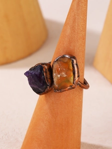 Close-up of raw purple amethyst and orange citrine on vintage bronze adjustable ring