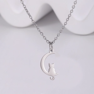 Polished stainless steel necklace featuring a cat sitting on a silver crescent moon pendant