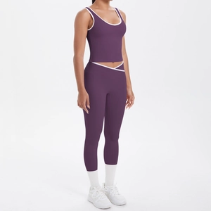 Detail of high-waist yoga pants with cross-over contrast waistband in dark purple