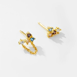 Asymmetric gold earrings with four-color faceted stones and a delicate fringe chain