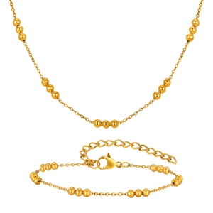 Golden stainless steel beaded jewelry set featuring a necklace and bracelet for women