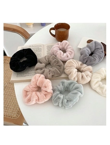 Detailed view of eight assorted soft faux rabbit fur scrunchies in various pastel colors