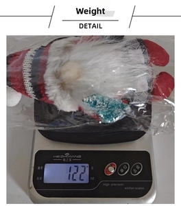 Detail view of a Christmas gnome plush being weighed on an electronic scale
