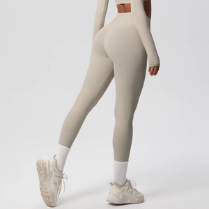 Rear view of high-waisted seamless beige yoga leggings and cropped long sleeve top