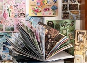 Detail view of vintage aesthetic stickers showing floral and butterfly motifs for scrapbooking
