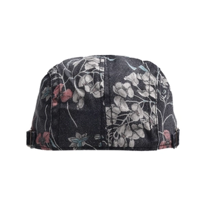 Detail of floral printed denim newsboy cap with vintage pattern and metal side buckle
