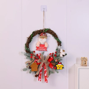 Detail of Christmas wreath with Santa Claus figure and Feliz Navidad sign on rattan
