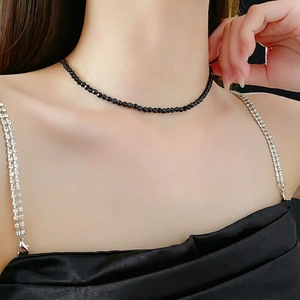 Minimalist black faceted bead choker necklace shown on a model for a luxury look