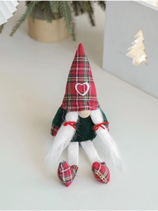 Detailed view of plush Christmas gnome with red green plaid hat and white braids