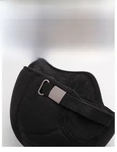 Detail of adjustable metal buckle and strap on back of black thermal baseball cap